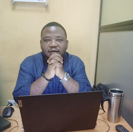 Femi at his desk